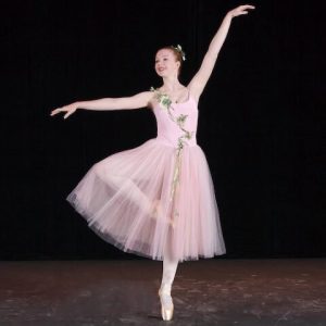Susie performs a passe with arms in allonge in a light pink romantic tutu