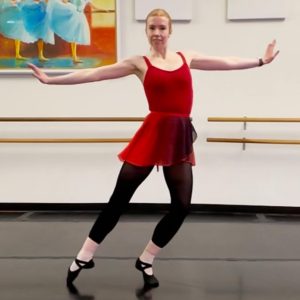 Susie dances in a studio while wearing a red/black ombre skirt