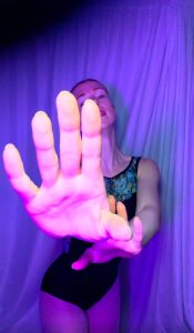 Close-up of Susie's hands reaching out emotionally