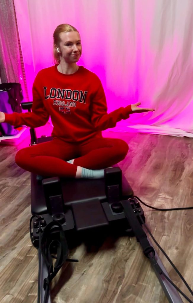 Susie Butler sits on her Pilates reformer